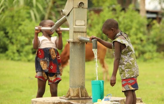 Kids using a handpump